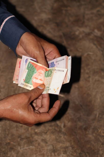 istock Hand with money، A boy counting Pakistani currency 2162859984