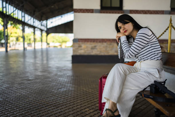 Young asian woman traveler with suitcase in the rail station