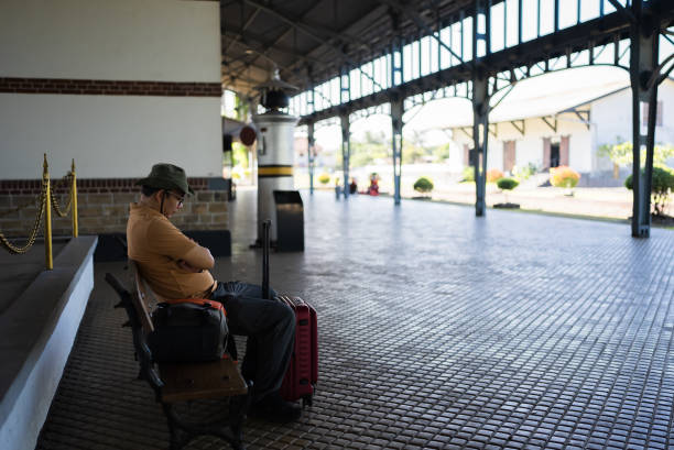 man traveler with suitcase in the rail station