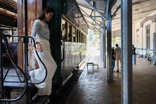 Young asian woman boarding a train