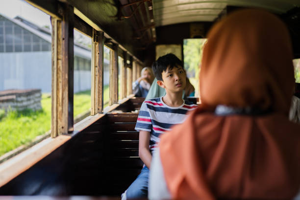 istock asian kid looking out a window traveling on a train 2162863058