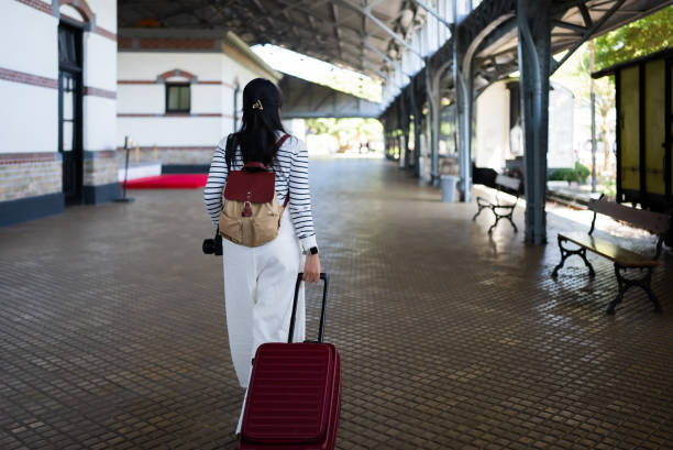 istock female traveler waiting the train 2162863088