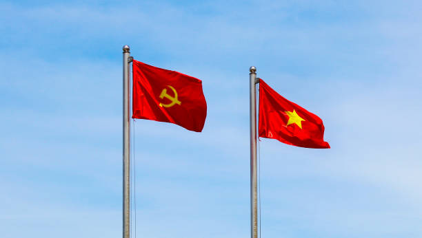 istock Vietnamese and Communist Flags Waving in the Sky 2162864941