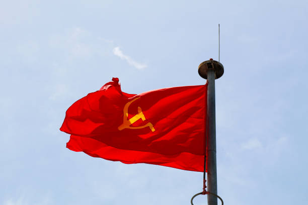 istock Vietnamese and Communist Flags Waving in the Sky 2162864955