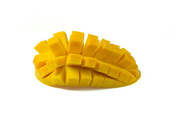 A ripe sliced mango fruit isolated on white background with clipping path closed up.