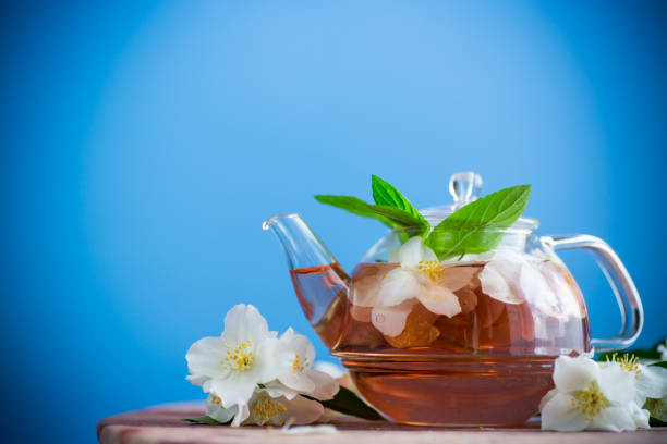 jasmine flower tea in a glass teapot .