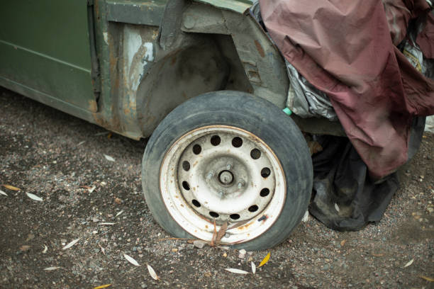 Car in landfill. Transport wheel. Broken machine. Destroyed transport.