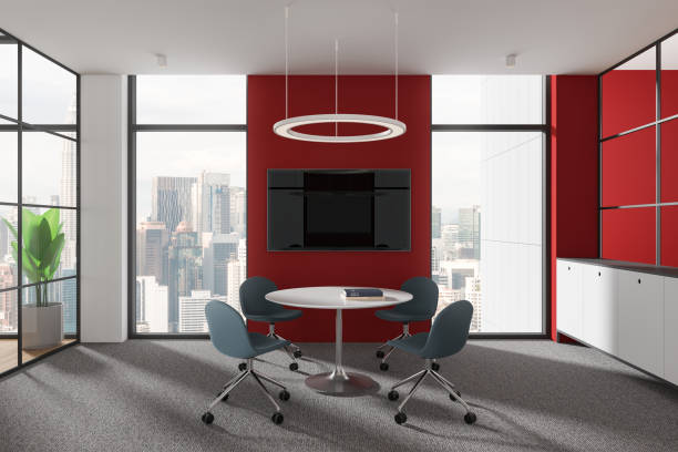 istock Modern office meeting room with blue chairs and a round table, large windows showcasing a cityscape, red walls, and elegant design. Concept of professional workspace. 3D Rendering 2162868122