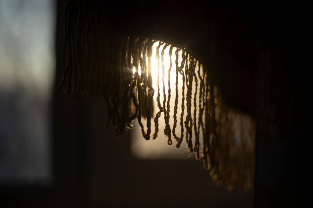 Light from the window. Fabric in rays of light. Morning rays. Warm feeling of dawn.