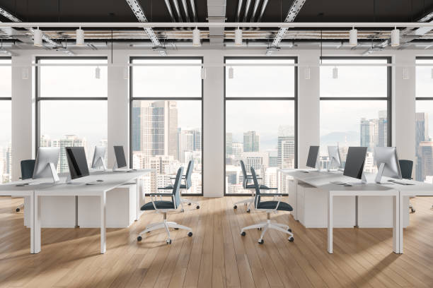 istock Modern open plan office with computers and chairs, cityscape background, concept of workspace efficiency, bright wooden floor.  3D Rendering 2162868468