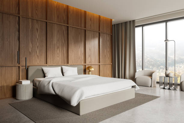 istock Wooden hotel bedroom interior with bed, armchairs and panoramic window 2162868595