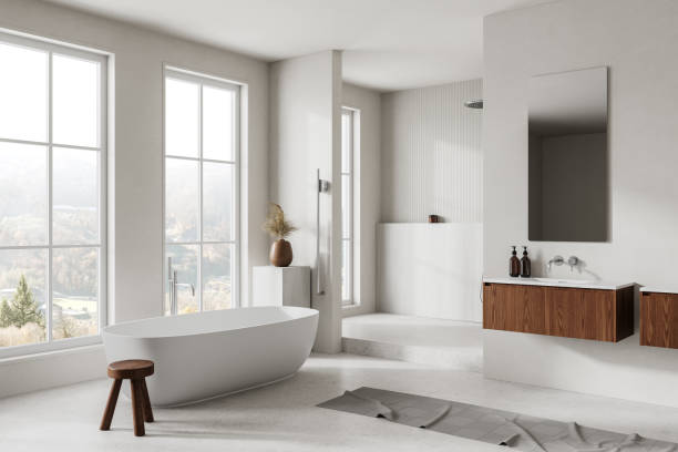 istock White hotel bathroom interior with sink, tub and shower. Panoramic window 2162869061