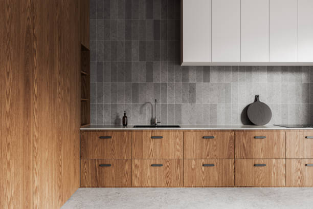 istock Modern wooden kitchen cabinets and grey backsplash in a minimalist kitchen. Light setting. Interior design concept.  3D Rendering 2162869166