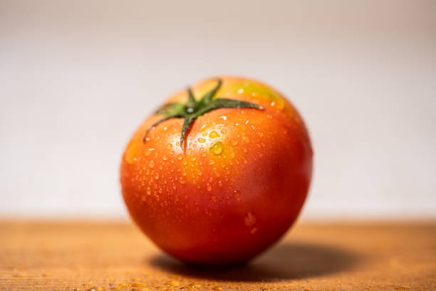 A fresh tomato on the chopping board
