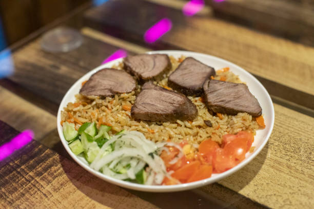 istock Rice with meat. Dinner on table. Pilaf in plate. 2162869323