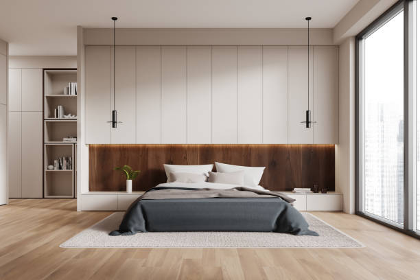 istock Stylish home bedroom interior with bed and shelf with decor, panoramic window 2162869345