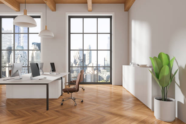 istock Modern office with desks, computers, wooden floor, cityscape view. Minimalist style. Bright, professional workspace.  3D Rendering 2162869366