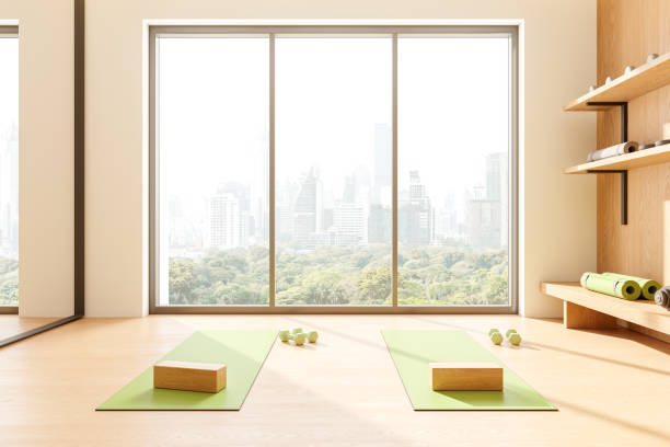 istock Stylish home gym interior with mat and shelf for equipment, panoramic window 2162869439
