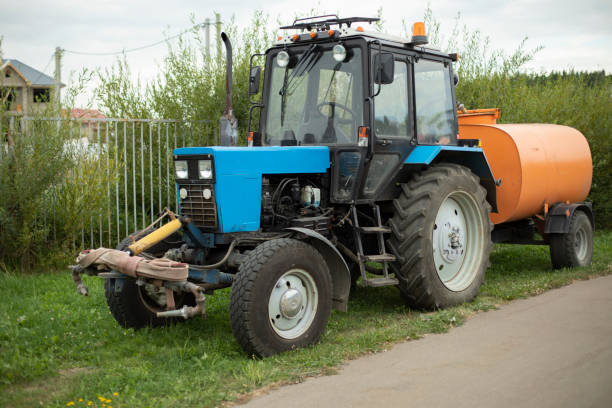 Tractor with water. Tractor equipped with system water irrigation. Agricultural machinery. Large wheels.