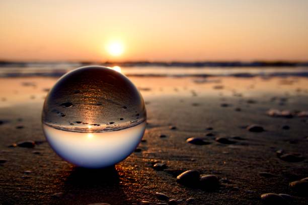 istock Crystal ball on the shoreline during sunrise 2162872309
