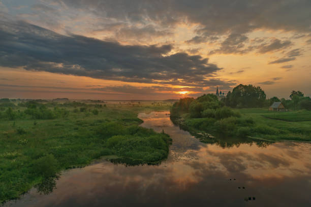 istock summer evening, sunset in yellow, orange and pink with clouds, background 2162873880
