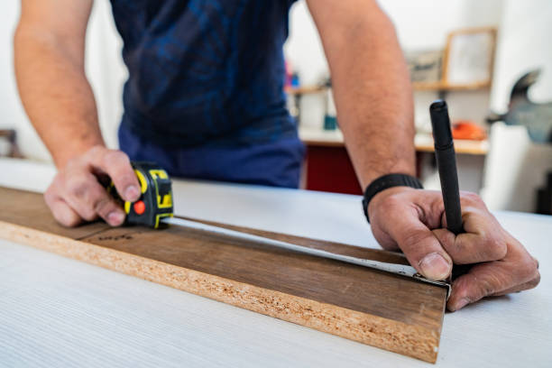 istock Close-up of a man's hands using tape measure in a carpentry 2162874987