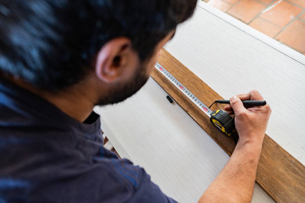 istock Close-up of a man using tape measure in a carpentry 2162874992