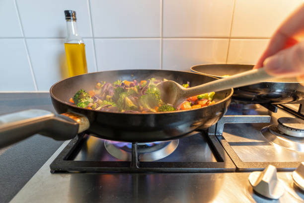istock cooking vegetables in a coated pan on a gas stove 2162876107