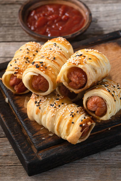 istock Homemade Sausage in dough rolls on plate 2162876572