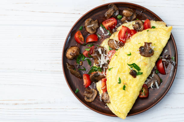 istock Omelette stuffed with mushrooms , tomatoes and parsley 2162876641