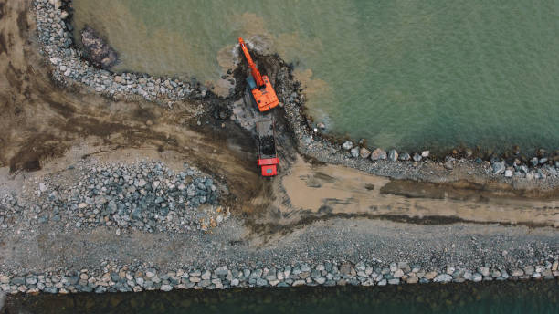 istock Truck Engineering Coastal Barrier Aerial. Coastal Barrier Building Process 2162878418