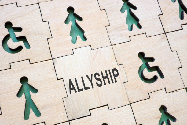 istock Puzzle with different figures and a word allyship. 2162878889