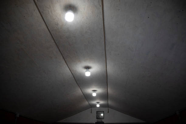 Lamps on the ceiling. Interior details. Light in the room. Polygonal roof.