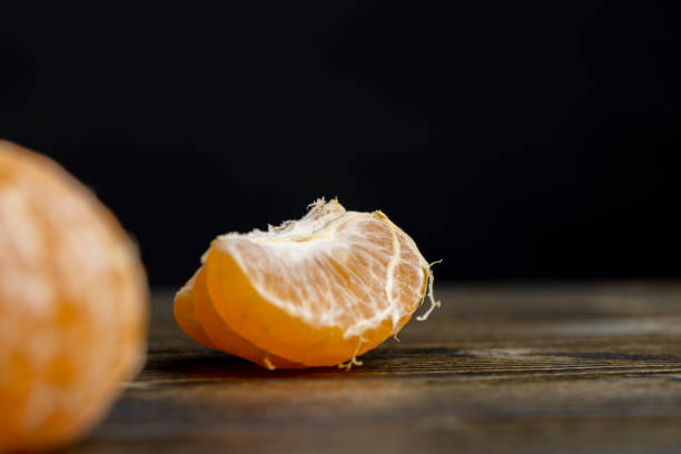 istock mandarin fruit without shell on a wooden blackboard 2162879759