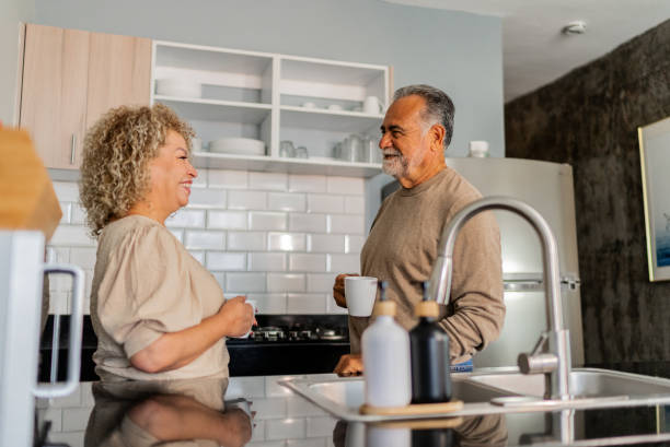 istock Senior couple talking and drinking coffee at kitchen 2162881693