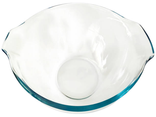 Studio shot of round empty clear glass casserole baking dish, high angle view, isolated on white background, high resolution stock image.