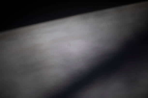 Light on the wall. Shadow on the wall. White surface in low light. Space Shadow .