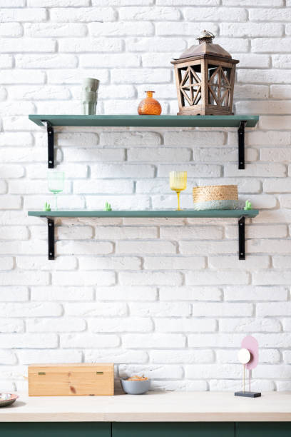 istock Empty kitchen countertop with Green Shelves on White Brick Wall 2162883326