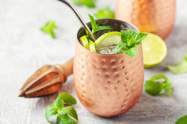 istock Alcohol cocktail mojito with lime and mint in copper glasses with ice. Summer refreshing drink 2162884297