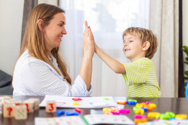 istock Mother and son high five at home 2162885390