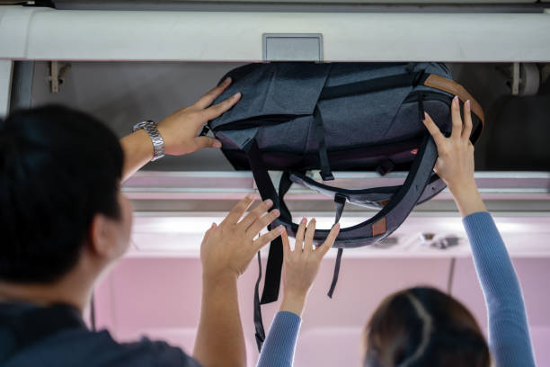 istock Passengers Storing Luggage Overhead on Transport 2162891126