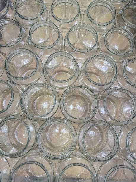istock Glass jars on a cardboard background - flat view. 2162893235