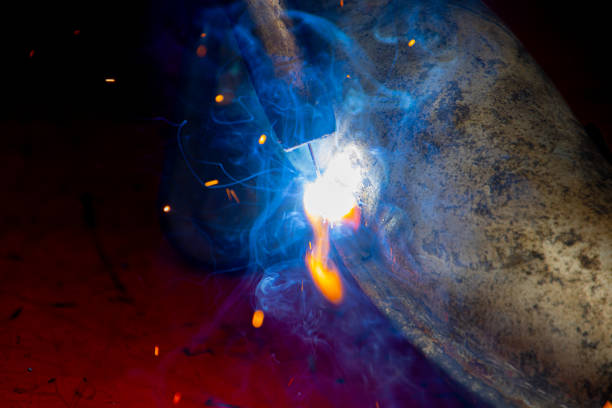 Metal welding. Work on steel. Fire from welding. Production details.