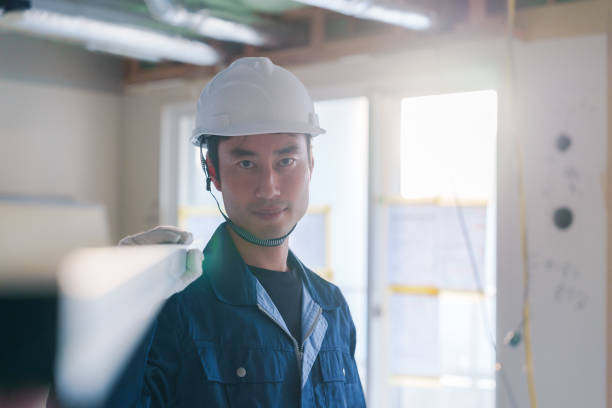 istock Male craftsman carrying materials at a construction site 2162894260