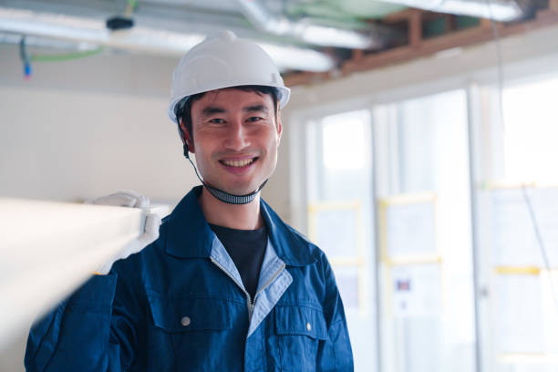 istock Male craftsman carrying materials at a construction site 2162894274