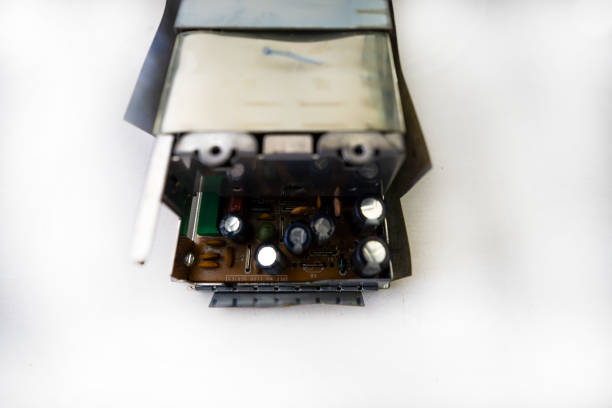 Video Cassette undergoing maintenance with several VHS and Cassette tapes