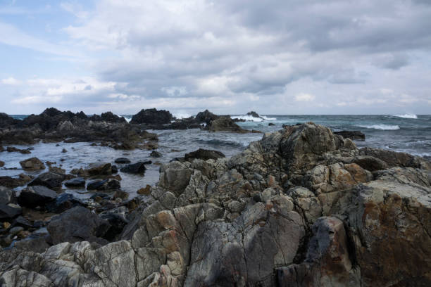 istock rocky beach and cloudy sea 2162896745