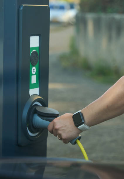 istock Close-up - young man charging his electric car 2162898037