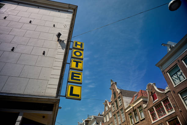 Old-fashioned vertical hotel sign on facade of building.
