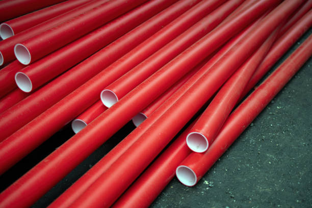 Many red plastic pipes for engineering networks in new houses